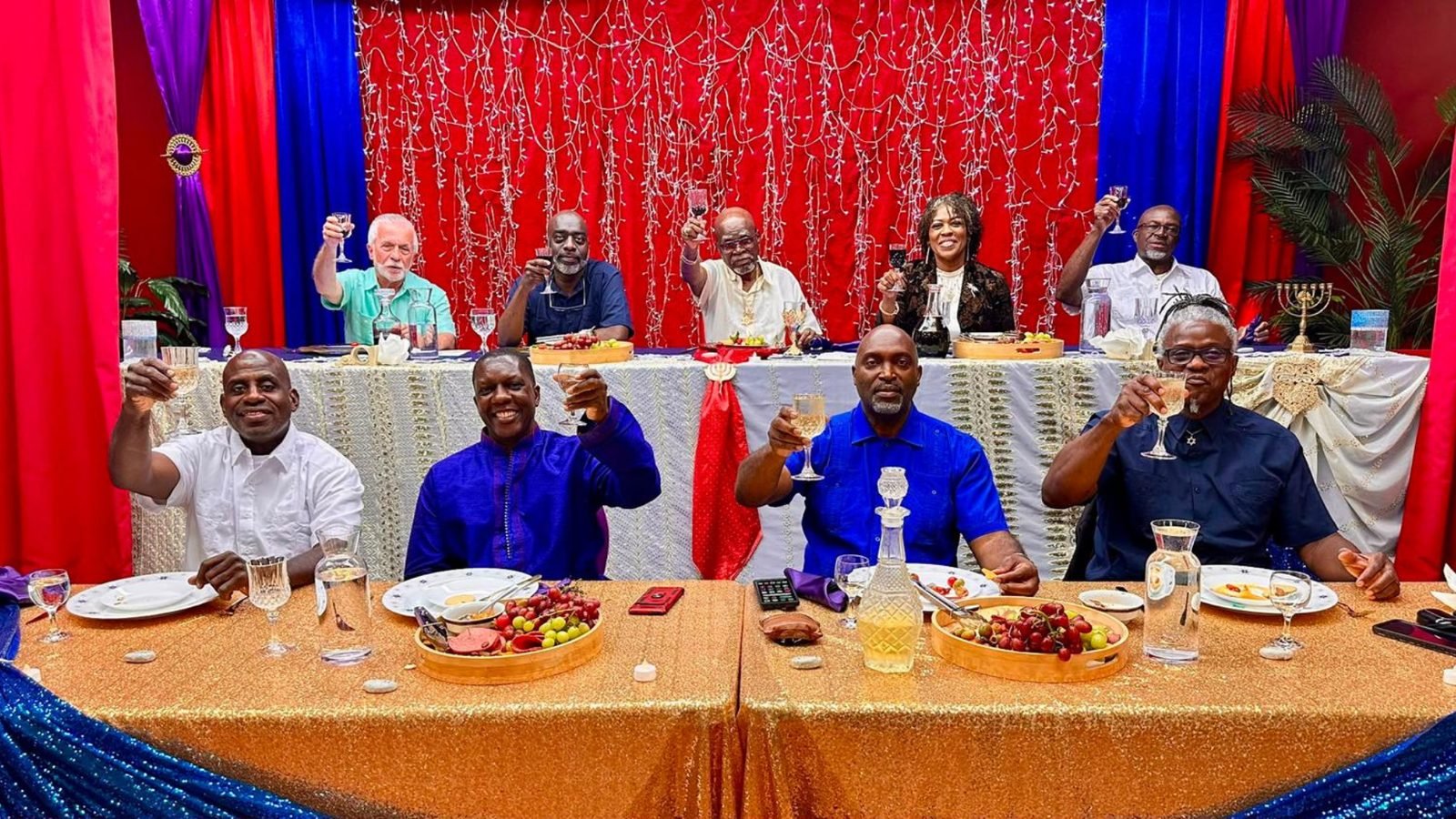 The head table raised in a toast at a feast.