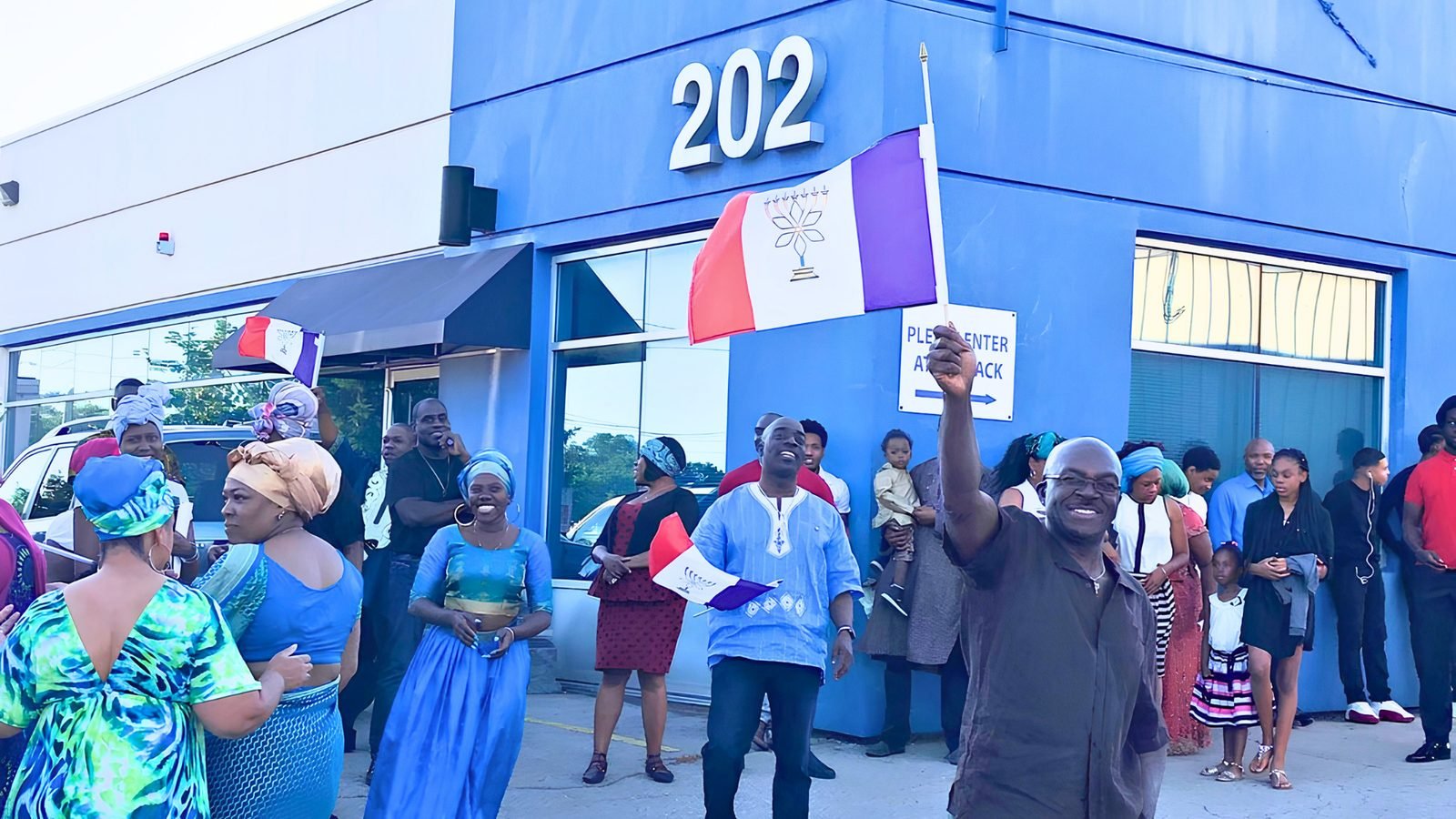 Brethren gathered outside 202 Bentworth Avenue beneath the nation’s flag.