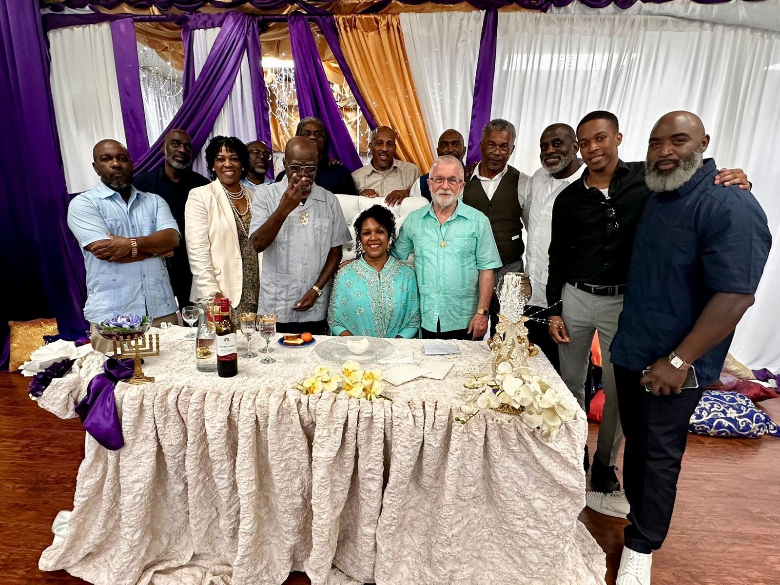 Members of the Nation gathered around a decorated table.