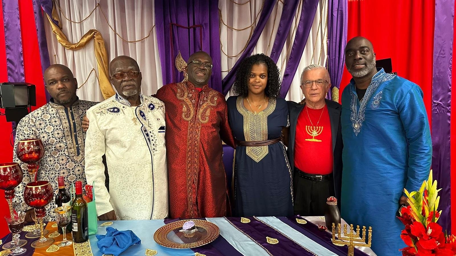 Brethren standing together at a feast table.